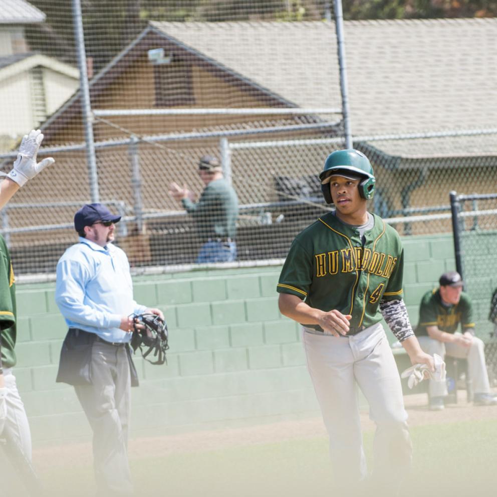 baseball players on the field with others in the dugout