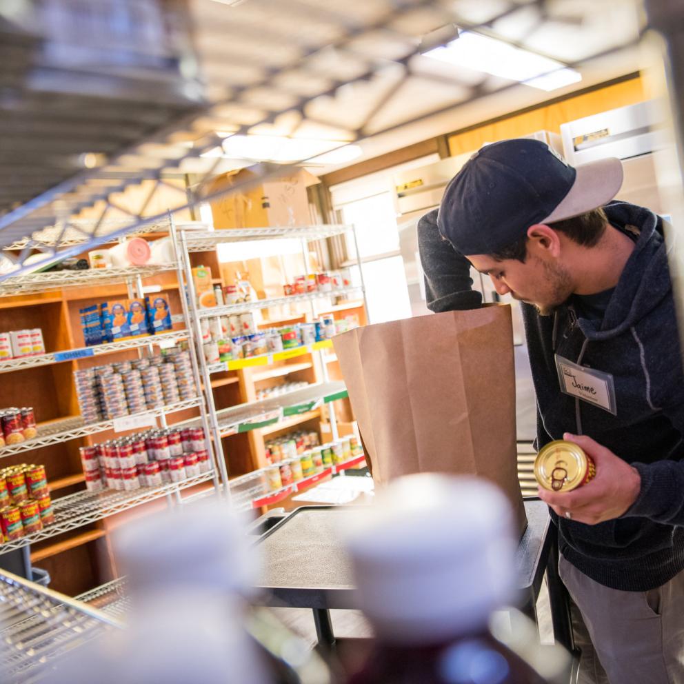 Student stocking cans at Food for People