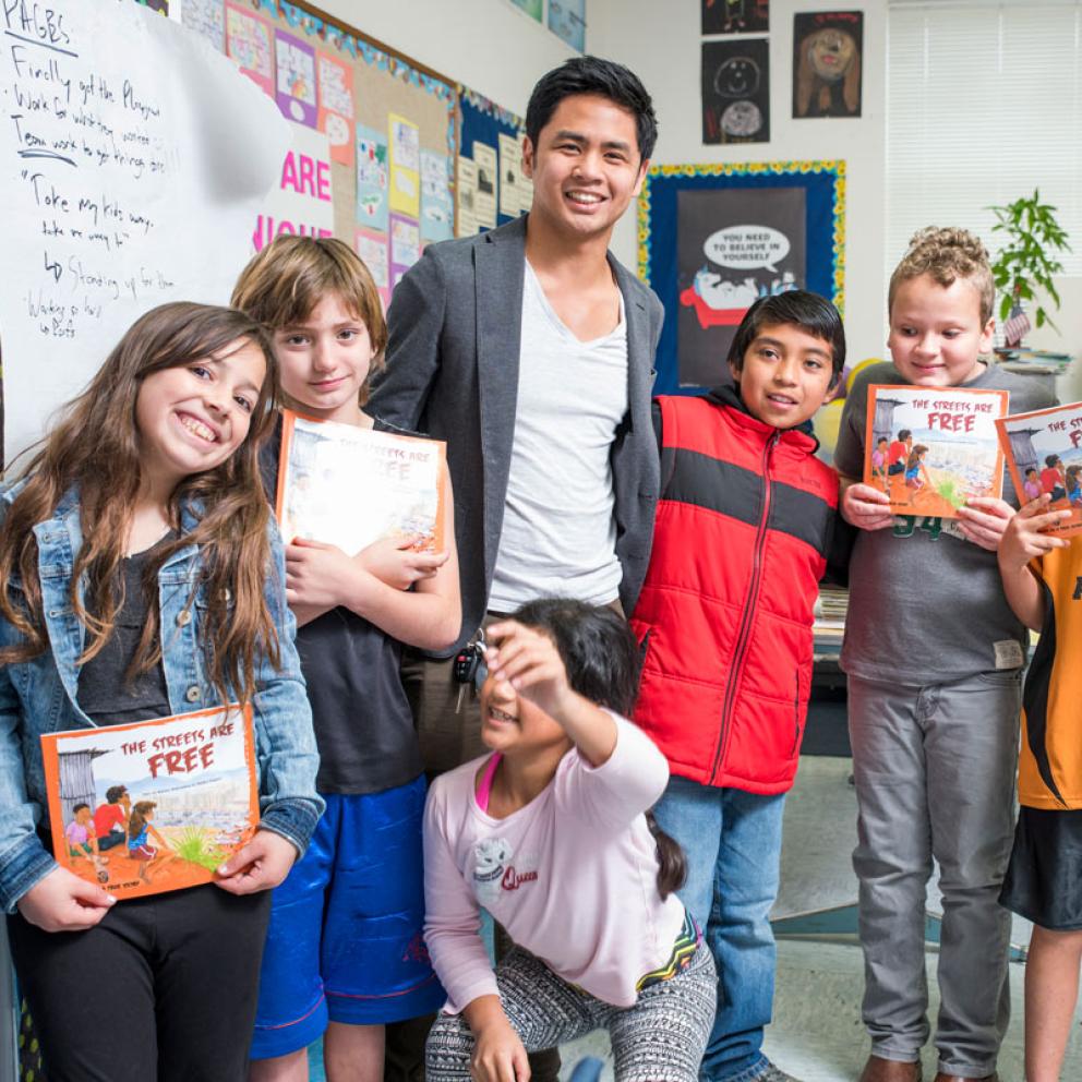 a student teacher with a group of elementary age kids