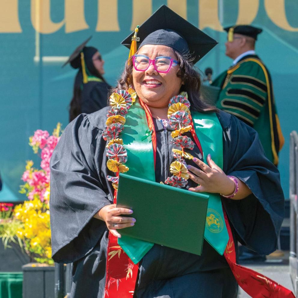 Students walking away from the podium at graduation