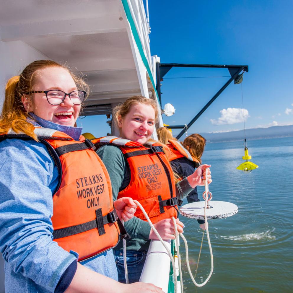 students on a big boat with life jackets on and big smiles