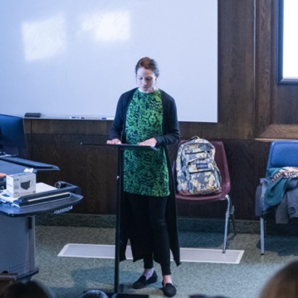 A woman standing in front of a class