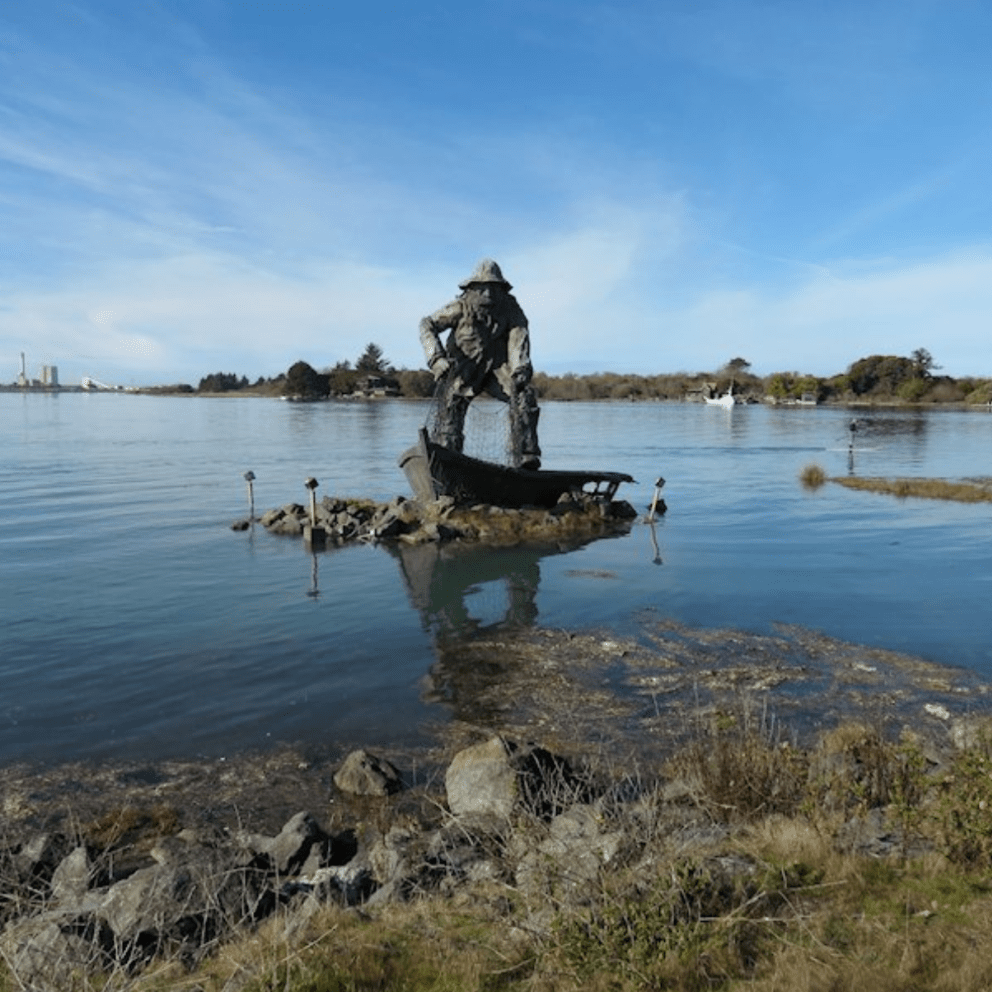 Image of fisherman statue on Woodley Island during a king tide