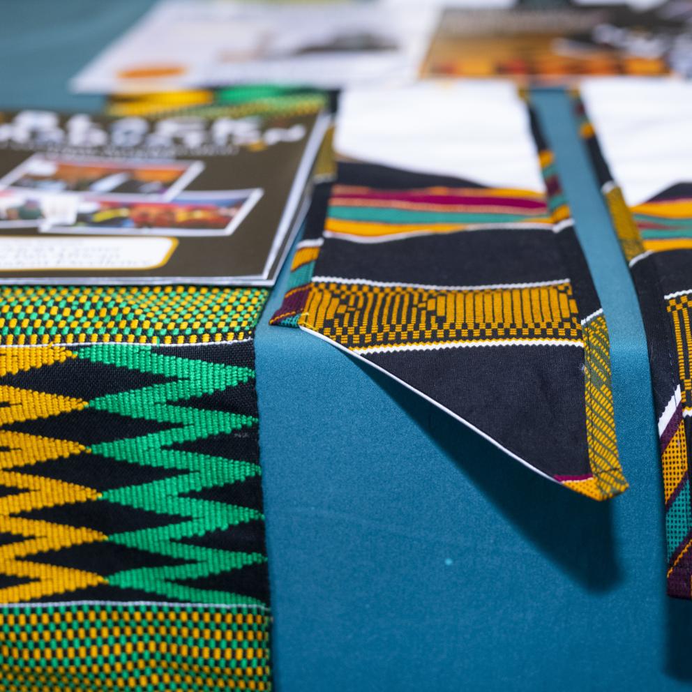 Close up of black grad stoles laid across a table.