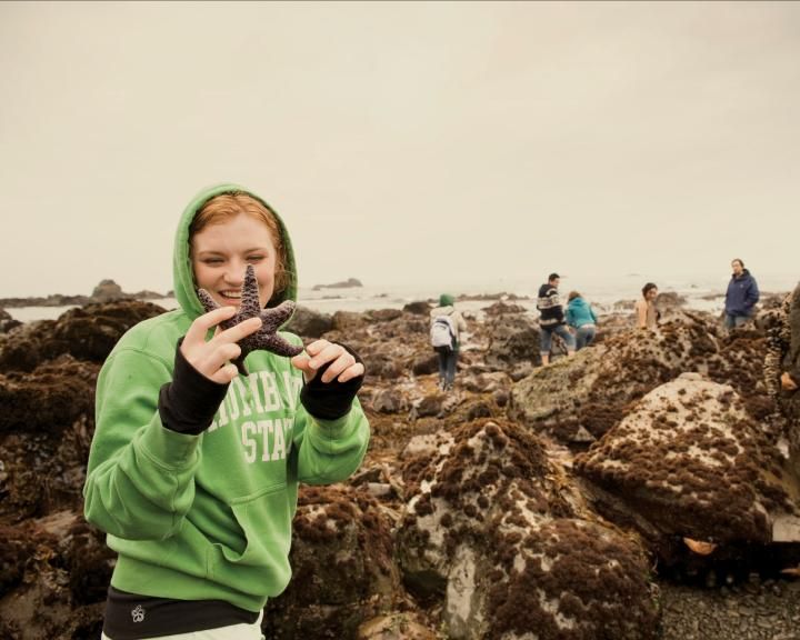 Student holding sea creatures