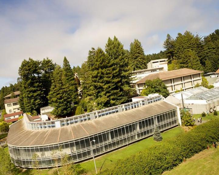 photo of existing building on campus with trees and grass