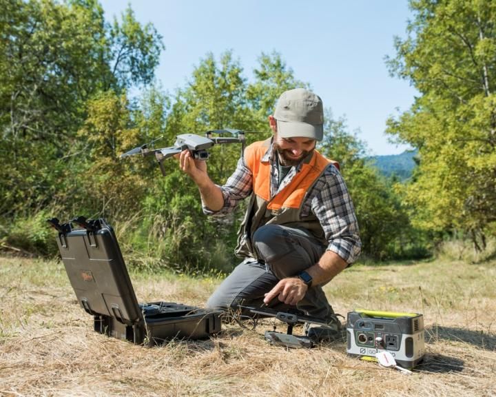 A forestry student using a drone