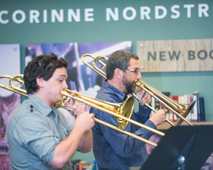 Music students performing at ideaFest in the lobby of the library