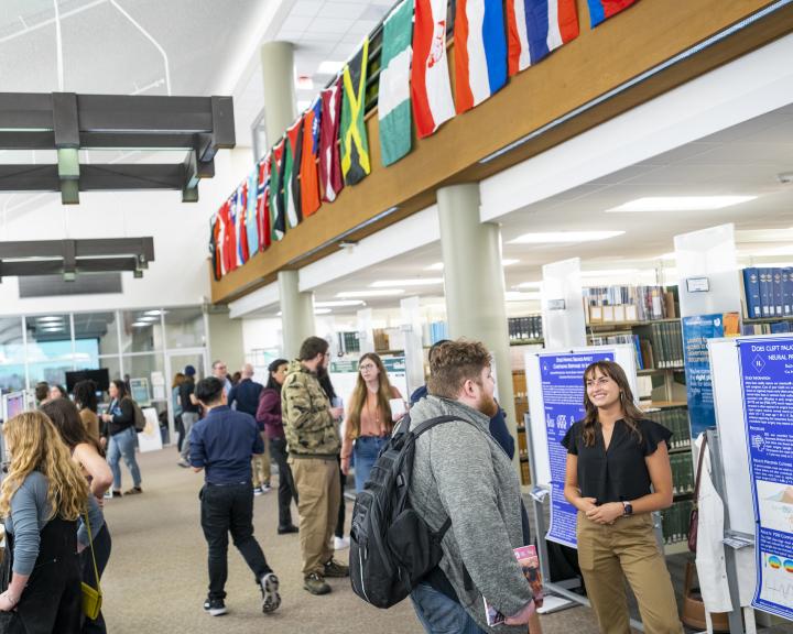 Library second floor reading room filled with student presenters with their posters