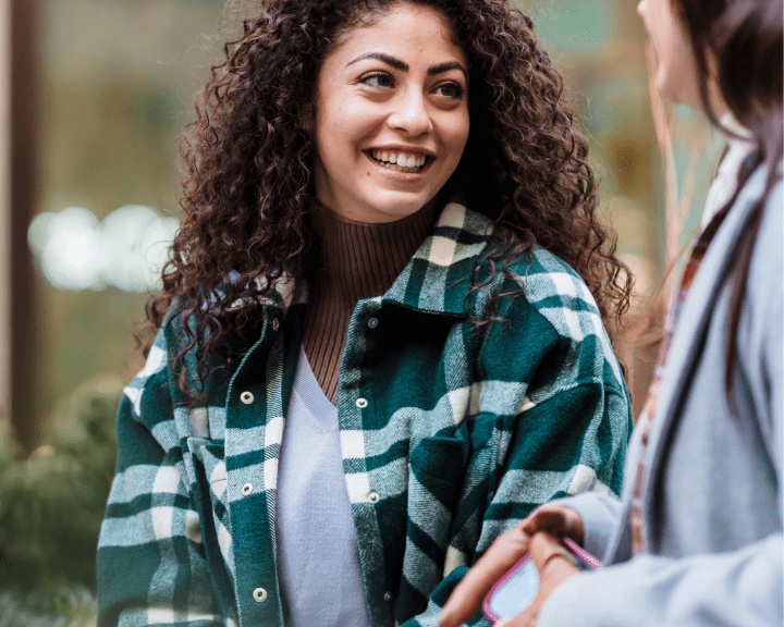 Two women smiling at each other