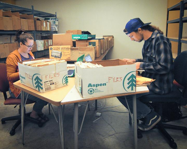 Students sort through boxes of material to organize the collection