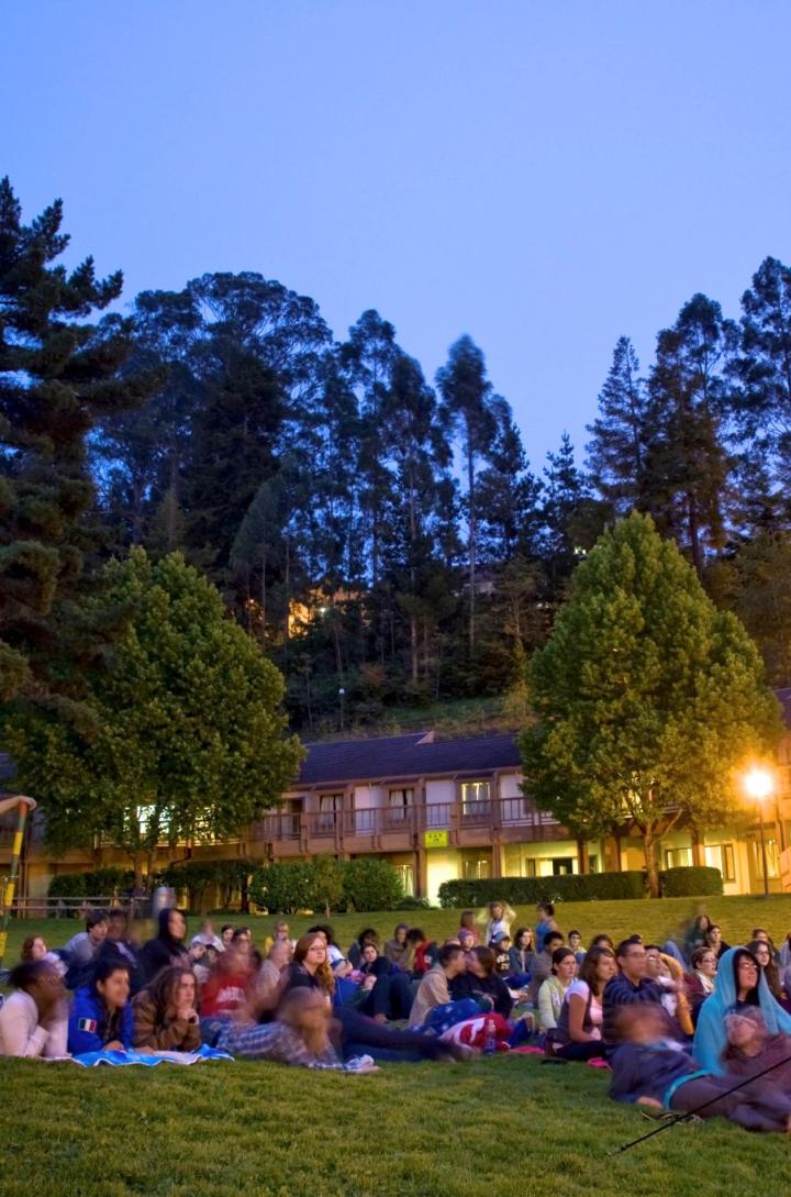students watching a movie in field