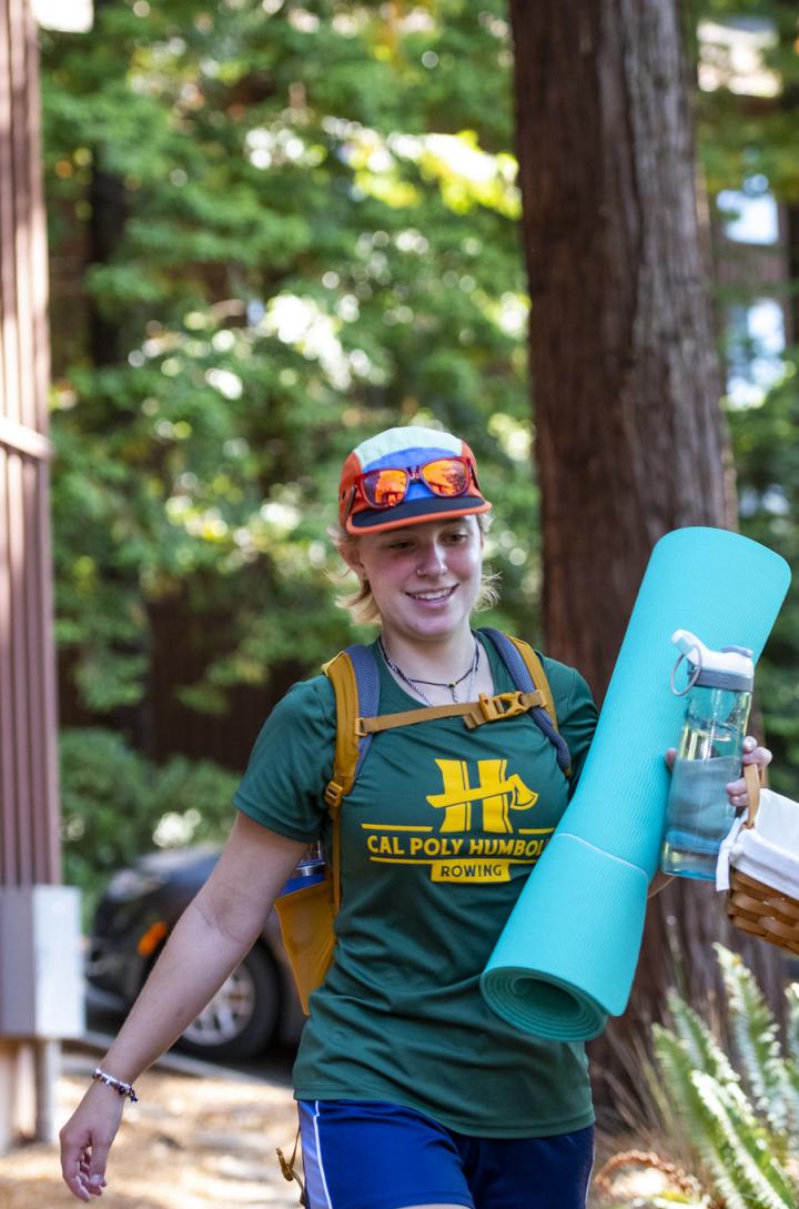student moving in with yoga mat