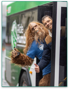 Photo of Bigfoot and a bus rider getting on the bus.