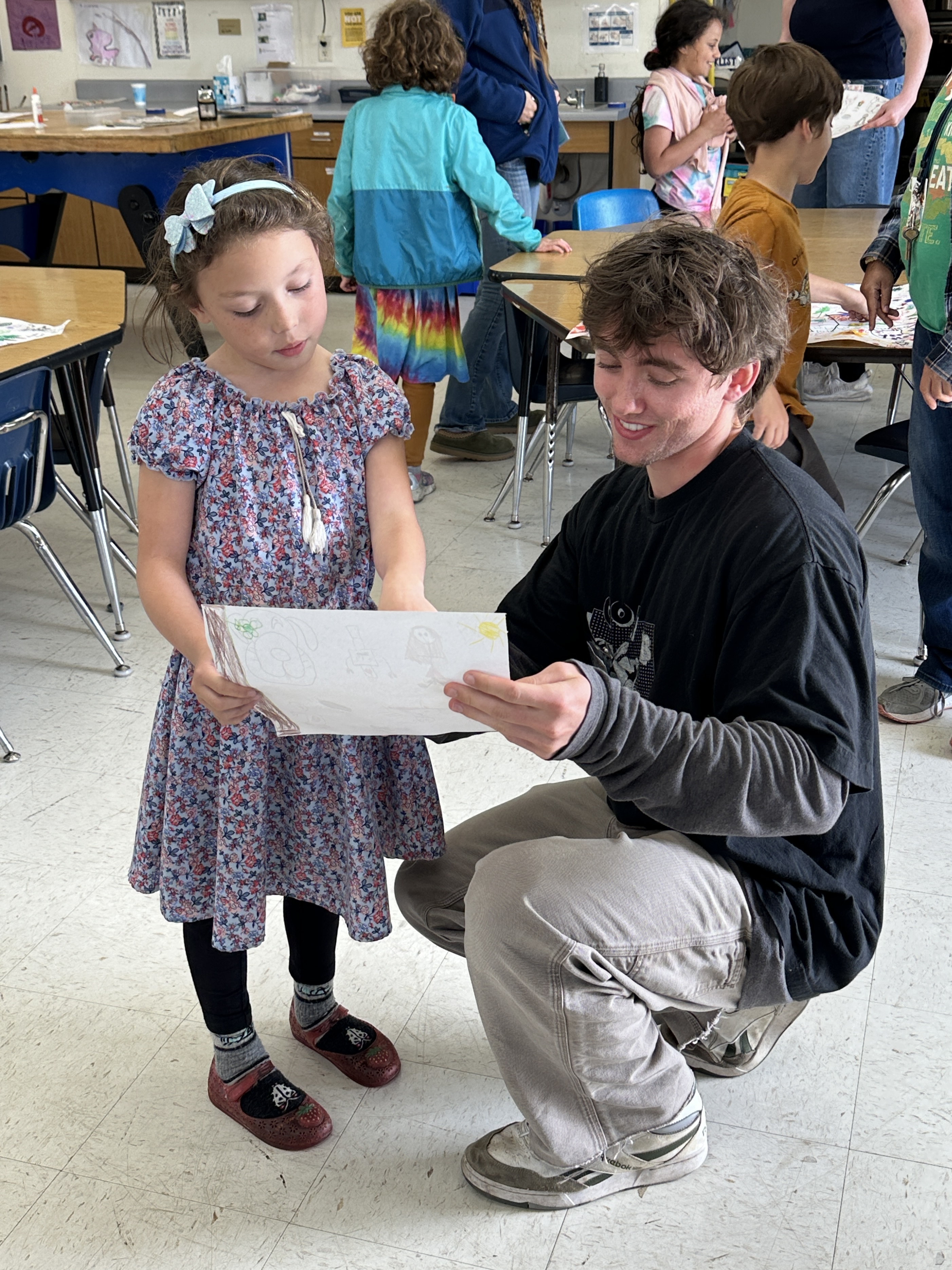 YMP Director, Jesse Sammel, admires a student art project. (Spring 2025)