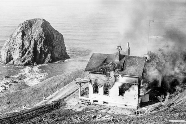Photo of a burnt house next to the ocean